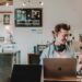 man sat in a coffee shop working to represent employee experience management