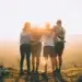 Team stood on a mountain celebrating success.